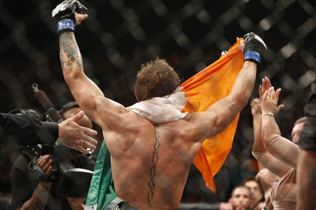 Conor McGregor celebrates after defeating Chad Mendes during their interim featherweight title mixed martial arts bout at UFC 189 Saturday, July 11, 2015, in Las Vegas. (AP Photo/John Locher)
