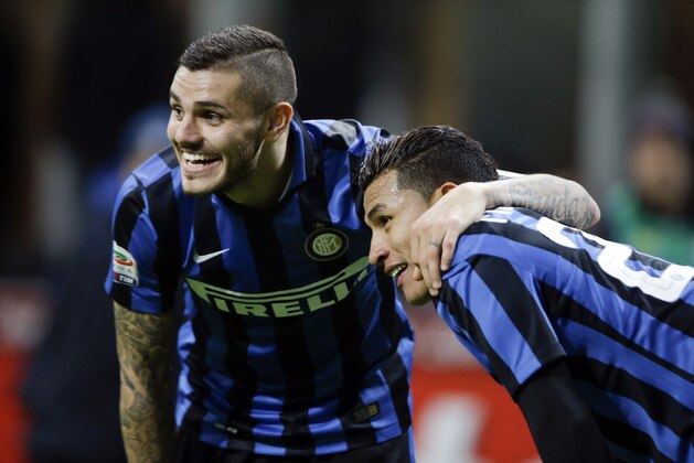Inter Milan's Jeison Murillo, right, celebrates with his teammate Mauro Icardi  after scoring during a Serie A soccer match between Inter Milan and Frosinone at the San Siro stadium in Milan, Italy, Nov. 22, 2015. (AP Photo/Luca Bruno)