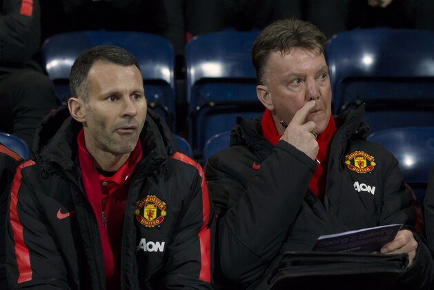 Manchester United's manager Louis van Gaal, right, takes his seat next to assistant manager Ryan Giggs before the English FA Cup Fifth Round soccer match between Preston and Manchester United at Deepdale Stadium in Preston, England, Monday Feb. 16, 2015.  (AP Photo/Jon Super)