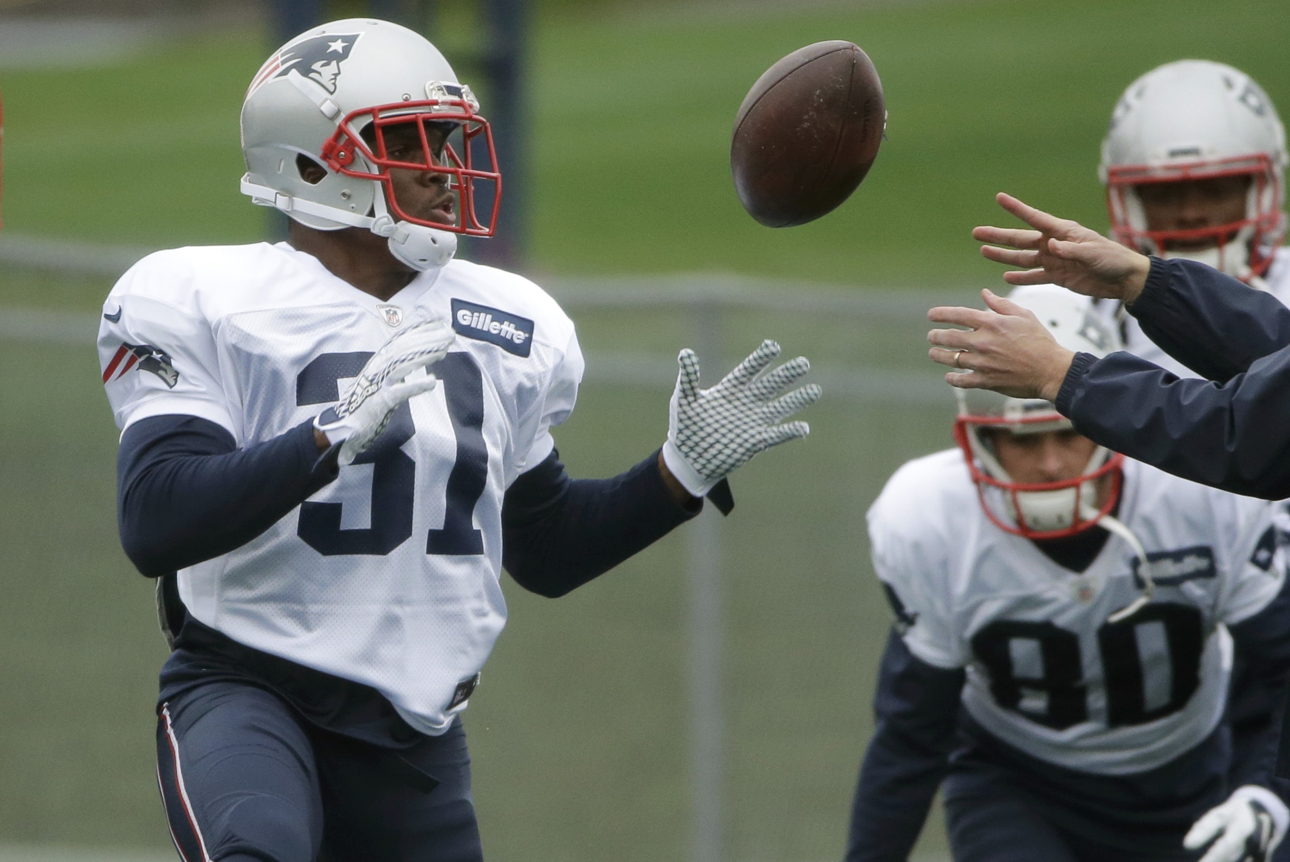 New England Patriots running back Trey Williams, left, catches the ball during an NFL football practice, Wednesday, Dec. 9, 2015, in Foxborough, Mass. The Patriots are to play the Houston Texans Sunday, Dec. 13, in Houston. Patriots wide receiver Danny Amendola prepares to toss the ball at right. (AP Photo/Steven Senne)