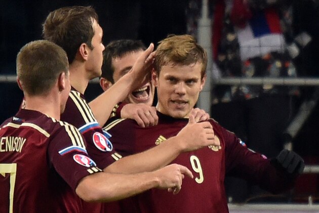 Russia's forward Aleksandr Kokorin (R) celebrates with teammates after scoring a goal during the UEFA Euro 2016 group G qualifying football match between Russia and Montenegro at the Otkrytie Arena stadium in Moscow on October 12, 2015.  AFP PHOTO / KIRILL KUDRYAVTSEV        (Photo credit should read KIRILL KUDRYAVTSEV/AFP/Getty Images)
