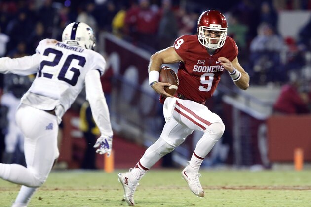 Oklahoma quarterback Trevor Knight (9) runs as TCU safety Derrick Kindred (26) closes in during the fourth quarter of an NCAA college football game in Norman, Okla., Saturday, Nov. 21, 2015. Oklahoma won 30-29. (AP Photo/Alonzo Adams)