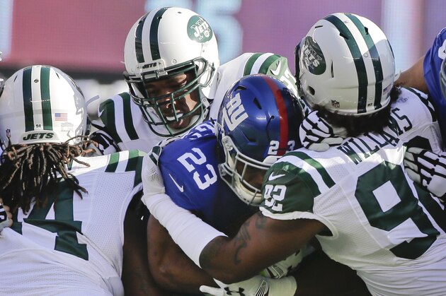 New York Giants running back Rashad Jennings (23) is tackled by New York Jets' Leonard Williams (92) during the first half of an NFL football game Sunday, Dec. 6, 2015, in East Rutherford, N.J. (AP Photo/Julie Jacobson)