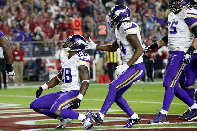 Minnesota Vikings running back Adrian Peterson (28) celebrates his touchdown run against the Arizona Cardinals with teammate Stefon Diggs (14) during the first half of an NFL football game, Thursday, Dec. 10, 2015, in Glendale, Ariz. (AP Photo/Ross D. Franklin)