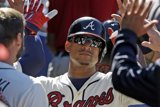 Atlanta Braves' Christian Bethancourt celebrates with teammates in the dugout after scoring a run during the eighth inning of a baseball game against the New York Mets, Sunday, Sept. 13, 2015, in Atlanta. (AP Photo/Butch Dill)