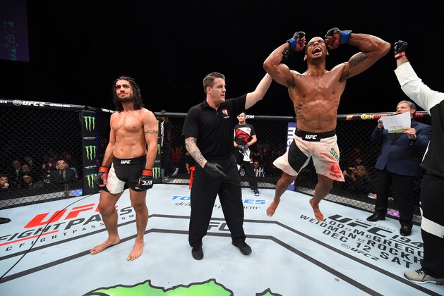 LAS VEGAS, NEVADA - DECEMBER 10:  (R) Thiago Santos celebrates his win over Elias Theodorou in their middleweight bout during the UFC Fight Night event at The Chelsea at the Cosmopolitan of Las Vegas on December 10, 2015 in Las Vegas, Nevada.  (Photo by Jeff Bottari/Zuffa LLC/Zuffa LLC via Getty Images)
