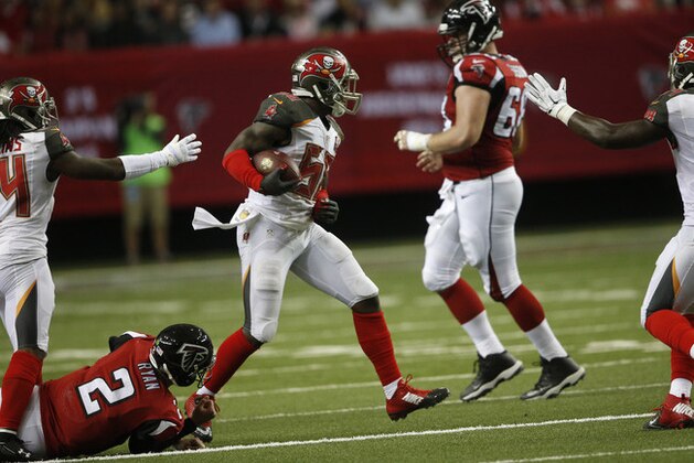 Tampa Bay Buccaneers middle linebacker Kwon Alexander (58) celebrates his interception as Atlanta Falcons quarterback Matt Ryan (2) lies on the turf during the first of an NFL football game, Sunday, Nov. 1, 2015, in Atlanta. (AP Photo/John Bazemore)