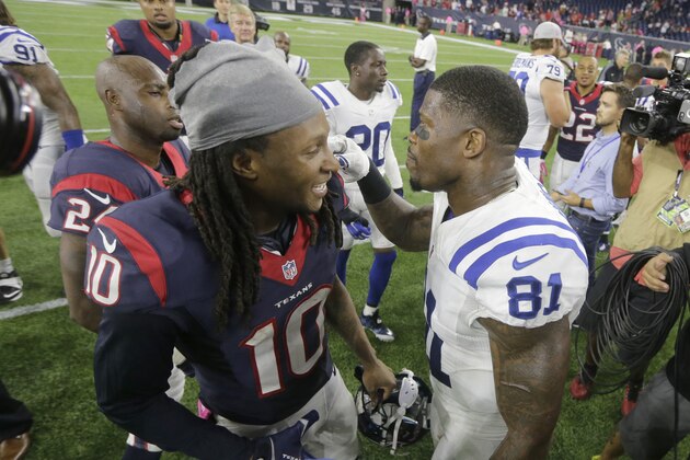 Houston Texans' DeAndre Hopkins (10) and Indianapolis Colts' Andre Johnson (81) greet at midfield following an NFL football game Thursday, Oct. 8, 2015, in Houston. (AP Photo/Patric Schneider)