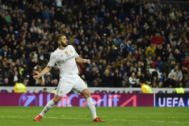 Real Madrid's French forward Karim Benzema celebrates his third goal during the UEFA Champions League Group A football match Real Madrid CF vs Malmo FF at the Santiago Bernabeu stadium in Madrid on December 8, 2015.   AFP PHOTO/ PIERRE-PHILIPPE MARCOU / AFP / PIERRE-PHILIPPE MARCOU        (Photo credit should read PIERRE-PHILIPPE MARCOU/AFP/Getty Images)