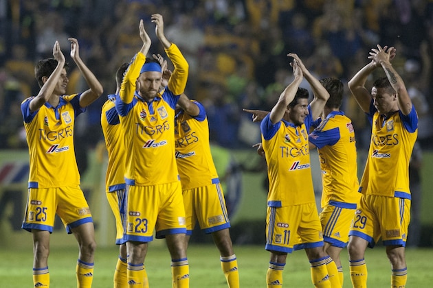 Tigres' players celebrate the end of the game against Pumas during the first leg of the final of the Mexican Apertura 2015 tournament football match at the Universitario stadium in Monterrey, Mexico on December 10, 2015. AFP PHOTO/Julio Cesar Aguilar / AFP / Julio Cesar Aguilar        (Photo credit should read JULIO CESAR AGUILAR/AFP/Getty Images)