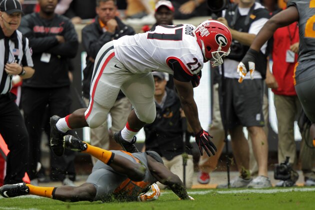 Georgia running back Nick Chubb (27) is tackled by Tennessee defensive back Emmanuel Moseley (12) during the first half of an NCAA college football game Saturday, Oct. 10, 2015, in Knoxville, Tenn. Chubb was injured on the play. (AP Photo/Wade Payne)