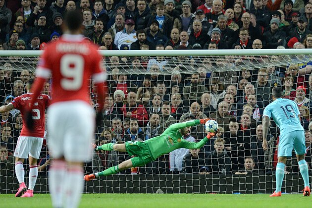 Manchester United's Spanish goalkeeper David de Gea (2nd R) makes a save during their UEFA Champions League Group B football match between Manchester United and PSV Eindhoven at the Old Trafford Stadium in Manchester, north west England on November 25, 2015. AFP PHOTO / OLI SCARFF / AFP / OLI SCARFF        (Photo credit should read OLI SCARFF/AFP/Getty Images)