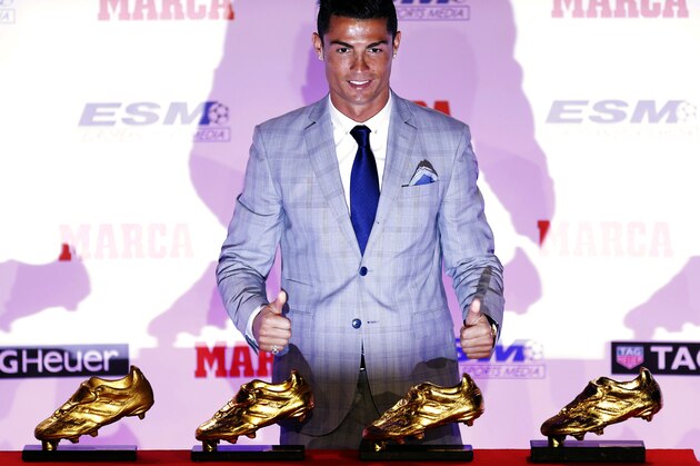 Real Madrid's striker Cristiano Ronaldo poses with the Golden Boot award for scoring the most goals in Europe's domestic leagues last season, during a ceremony in Madrid, Spain, Tuesday, Oct. 13, 2015. This is the fourth Golden Boot award Ronaldo has won during his career and his third since joining Real Madrid, where he scored 48 goals during the last La Liga season. (AP Photo/Francisco Seco)