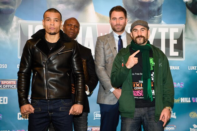 British boxer Chris Eubank Jr (L) and Irish boxer Gary 'Spike' O'Sullivan (R) pose in front of English, aka former boxing champion Chris Eubank Snr (back L) and boxing promoter Eddie Hearn (back R) following a press conference in east London on December 10, 2015, promoting their upcoming non-title middleweight fight on December 12. AFP PHOTO / LEON NEAL / AFP / LEON NEAL        (Photo credit should read LEON NEAL/AFP/Getty Images)
