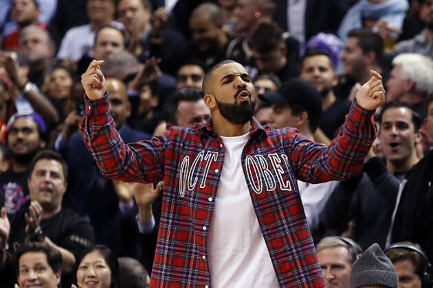 TORONTO, ON - NOVEMBER 25:  Singer Drake celebrates a Raptors score on 'Drake Night' during an NBA game between the Cleveland Cavaliers and the Toronto Raptors at the Air Canada Centre on November 25, 2015 in Toronto, Ontario, Canada.  NOTE TO USER: User expressly acknowledges and agrees that, by downloading and or using this photograph, User is consenting to the terms and conditions of the Getty Images License Agreement.  (Photo by Vaughn Ridley/Getty Images)
