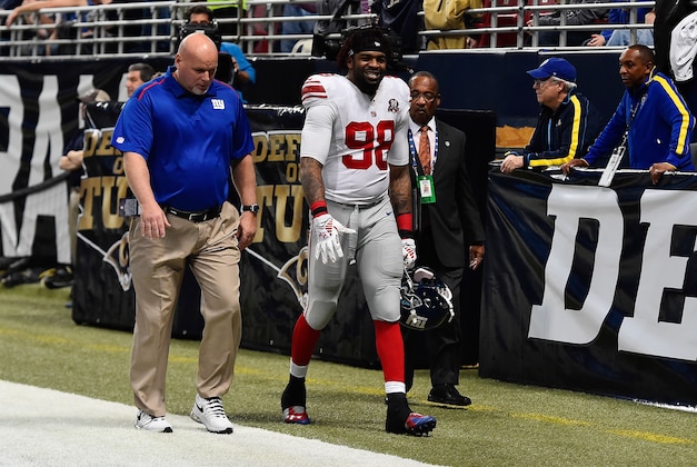 Dec 21, 2014; St. Louis, MO, USA; New York Giants defensive end Damontre Moore (98) is escorted off the field after being ejected from the game against the St. Louis Rams during the first half at the Edward Jones Dome. Mandatory Credit: Jasen Vinlove-USA TODAY Sports