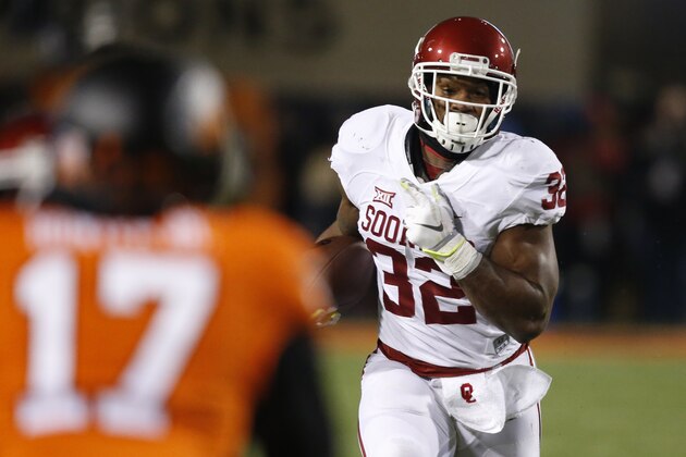 Oklahoma running back Samaje Perine (32) carries against Oklahoma State cornerback Michael Hunter (17) in the second quarter of an NCAA college football game in Stillwater, Okla., Saturday, Nov. 28, 2015. (AP Photo/Sue Ogrocki)
