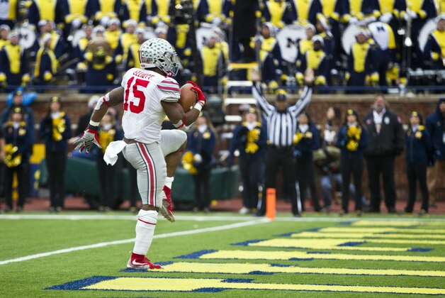 Ohio State running back Ezekiel Elliott (15) high steps into the end zone to score a touchdown in the second quarter of an NCAA college football game against Michigan in Ann Arbor, Mich., Saturday, Nov. 28, 2015. (AP Photo/Tony Ding)