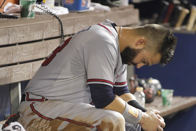 Atlanta Braves left fielder Nick Swisher (23) reacts in the dugout after he was tagged out at second base in the fourth inning of play against the Miami Marlins during a baseball game in Miami, Saturday, Sept. 26, 2015. (AP Photo/Joe Skipper)