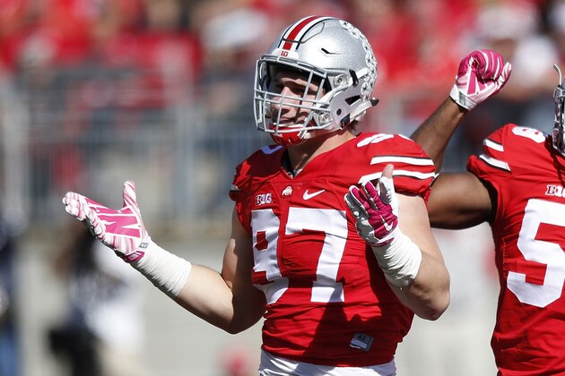 COLUMBUS, OH - OCTOBER 10: Joey Bosa #97 and Tyquan Lewis #59 of the Ohio State Buckeyes celebrate after a sack against the Maryland Terrapins during a game at Ohio Stadium on October 10, 2015 in Columbus, Ohio. The Buckeyes defeated the Terrapins 49-28. (Photo by Joe Robbins/Getty Images)