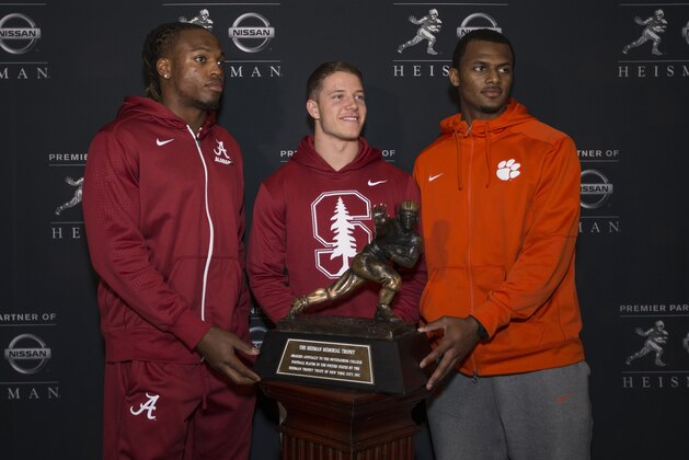 NEW YORK - DECEMBER 11: Heisman finalists Derrick Henry, running back for the University of Alabama, Christian McCaffery, running back for Stanford University and Deshaun Watson, quarterback for Clemson University, pose with the Heisman Trophy during media availability on December 11, 2015 at the Marriott Marquis in New York City. NOTE TO USER: Photographer approval needed for all Commercial License requests. (Photo by Kelly Kline/Getty Images for The Heisman)
