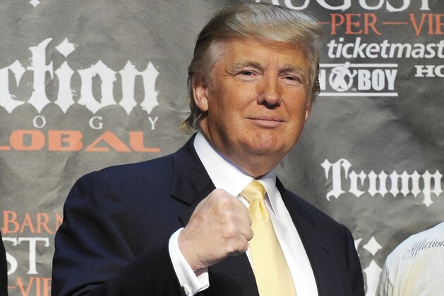 US real estate mogul Donald Trump (C) poses with Mixed Martial Art (MMA) heavyweight fighters US Josh Barnett (L) and Russia's Fedor Emelianenko in New York on June 03, 2009 during a press conference to introduce a World MMA Championship which will take place between the two fighters. The upcoming fight is scheduled to take place on August, 1, 2009 in Anaheim, California.       AFP PHOTO/Emmanuel Dunand (Photo credit should read EMMANUEL DUNAND/AFP/Getty Images)