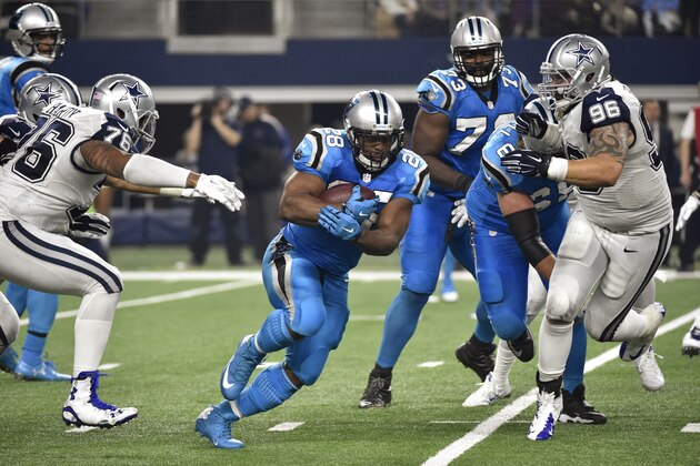 Carolina Panthers running back Jonathan Stewart (28) finds room between Dallas Cowboys' Greg Hardy (76) and Nick Hayden (96) during the second half of an NFL football game, Thursday, Nov. 26, 2015, in Arlington, Texas. (AP Photo/Michael Ainsworth)
