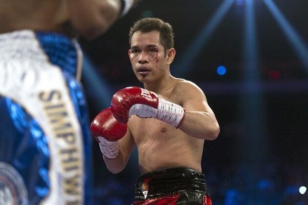 Simpiwe Vetyeka of South Africa and Nonito Donaire (C) of the Philippines during their WBA featherweight title boxing match in Macau on May 31, 2014. Donaire won the fight. AFP PHOTO / ANTHONY WALLACE        (Photo credit should read ANTHONY WALLACE/AFP/Getty Images)
