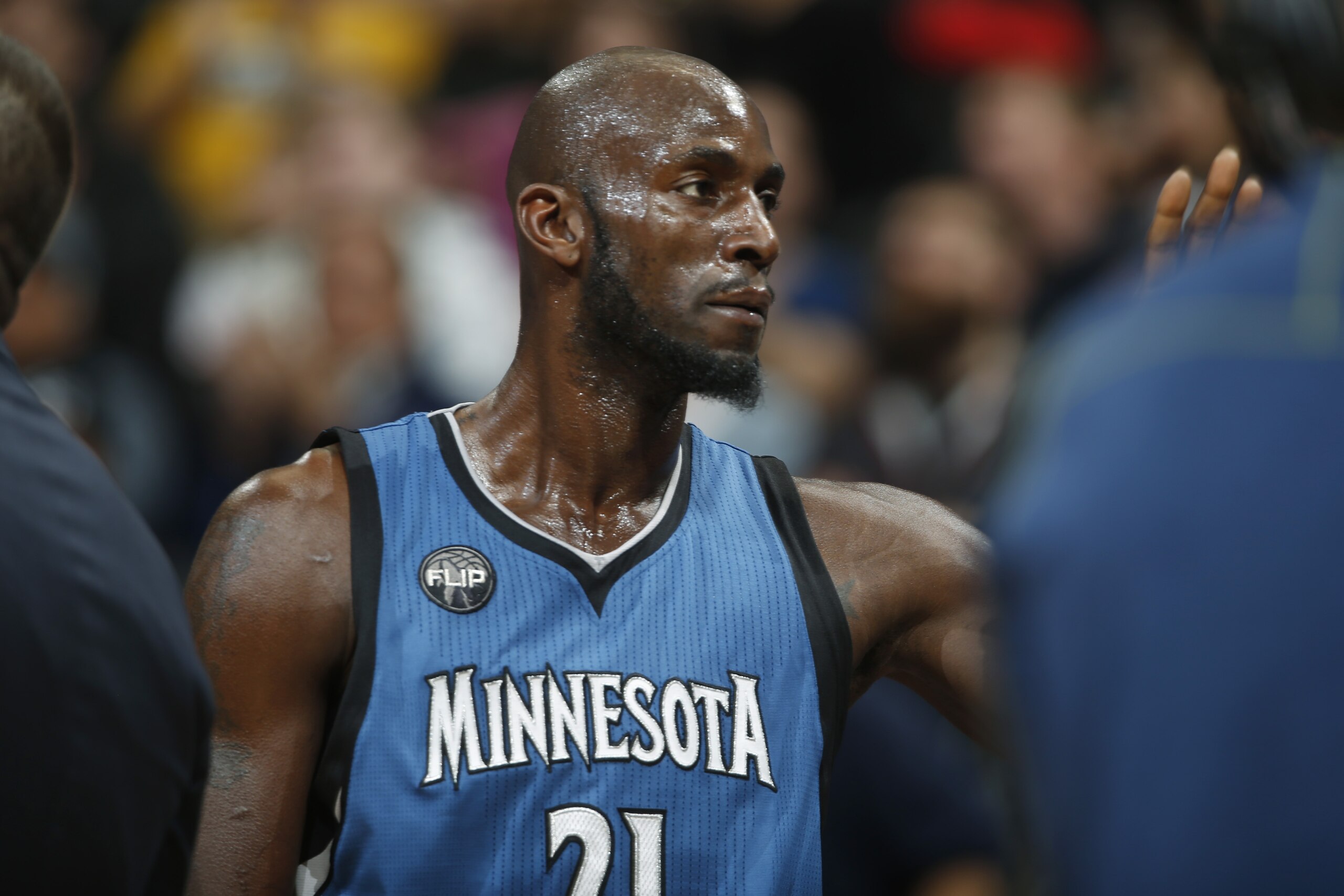 Minnesota Timberwolves forward Kevin Garnett waves to the crowd after eclipsing the existing record for total defensive rebounds held by Karl Malone at 11,406 in the first half of an NBA basketball game against the Denver Nuggets Friday, Dec.11, 2015, in Denver. (AP Photo/David Zalubowski)
