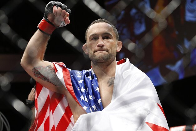 Frankie Edgar celebrates after defeating Chad Mendes in a featherweight bout during The Ultimate Fighter finale Friday, Dec. 11, 2015, in Las Vegas. (AP Photo/John Locher)