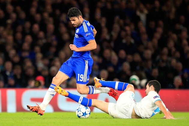 Chelsea's Diego Costa, left, drives the ball past Porto’s Ivan Marcano during the Champions League group G soccer match between Chelsea and FC Porto at Stamford Bridge stadium in London, Wednesday, Dec. 9, 2015.(AP Photo/Alastair Grant)