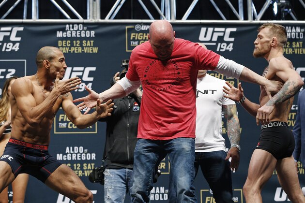 UFC president Dana White, center, stands between Conor McGregor, right, and Jose Aldo during the weigh-in for UFC 194 Friday, Dec. 11, 2015, in Las Vegas. McGregor and Aldo are scheduled to fight in a featherweight championship bout Saturday in Las Vegas. (AP Photo/John Locher)