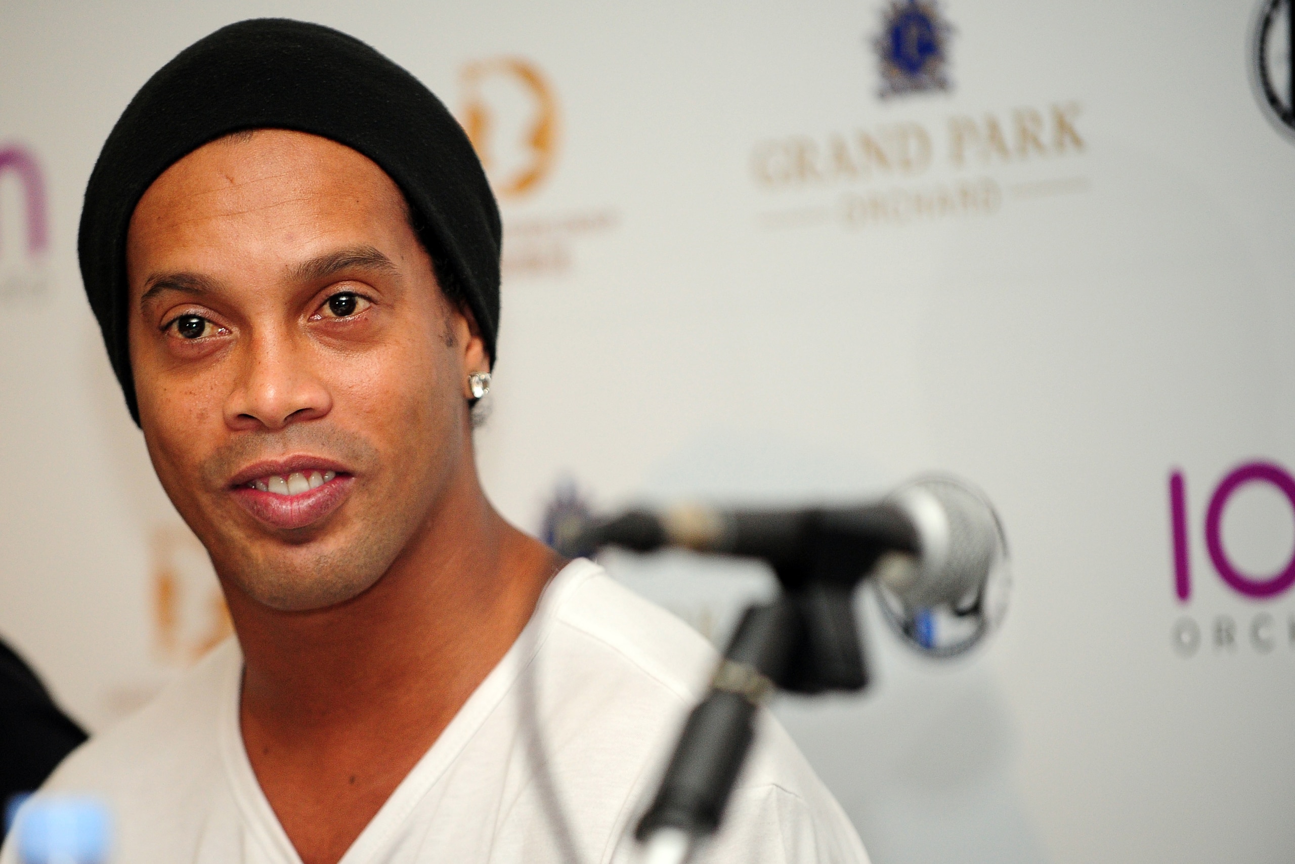 Brazil's football player Ronaldinho attends an agreement signing ceremony with local football club Tampines Rovers in Singapore on December 10, 2015. Brazilian legend Ronaldinho on December 10 signed an agreement to establish a football academy in soccer-mad Singapore, the local club that he partnered with said. AFP PHOTO / MOHD FYROL / AFP / MOHD FYROL        (Photo credit should read MOHD FYROL/AFP/Getty Images)