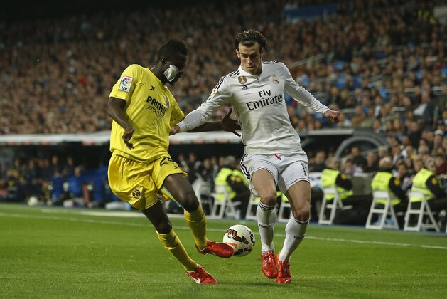 Real Madrid's Gareth Bale, right, in action with Villarreal’s Eric Bailly, left, during a Spanish La Liga soccer match between Real Madrid and Villarreal at the Santiago Bernabeu stadium in Madrid, Spain, Sunday, March 1, 2015. (AP Photo/Andres Kudacki)