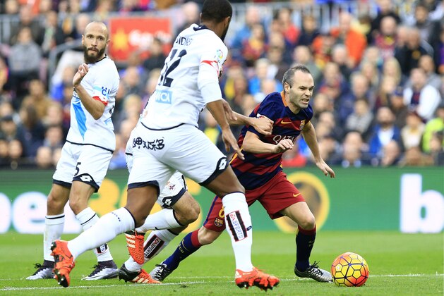 FC Barcelona's Spanish midfielder Iniesta (R) vies for a ball during the Spanish league football match FC Barcelona vs Deportivo de La Coruna at the Camp Nou stadium in Barcelona on December 12, 2015. AFP PHOTO/ PAU BARRENA / AFP / PAU BARRENA        (Photo credit should read PAU BARRENA/AFP/Getty Images)