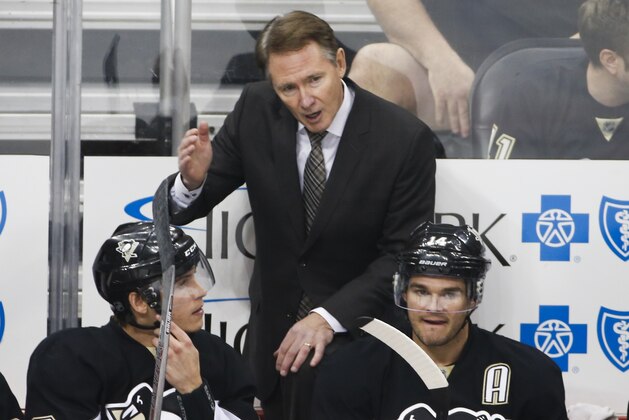 Pittsburgh Penguins head coach Mike Johnston stands behind his bench during an NHL hockey game against the St. Louis Blues in Pittsburgh Wednesday, Nov. 25, 2015.(AP Photo/Gene J. Puskar)