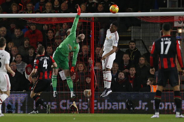Manchester United's Spanish goalkeeper David de Gea (C) attempts to save a shot from Bournemouth's English midfielder Junior Stanislas (Not pictured) after he scored his team's first goal during the English Premier League football match between Bournemouth and Manchester United at the Vitality Stadium in Bournemouth, southern England on December 12, 2015. AFP PHOTO / IKIMAGES

RESTRICTED TO EDITORIAL USE. No use with unauthorised audio, video, data, fixture lists, club/league logos or 'live' services. Online in-match use limited to 45 images, no video emulation. No use in betting, games or single club/league/player publications. / AFP / IKIMAGES / IAN KINGTON        (Photo credit should read IAN KINGTON/AFP/Getty Images)