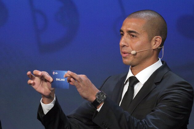 Former French international soccer player David Trezeguet holds up the team name of England during the Euro 2016 soccer championships draw in Paris Saturday, Dec. 12, 2015.  (AP Photo/Christophe Ena)