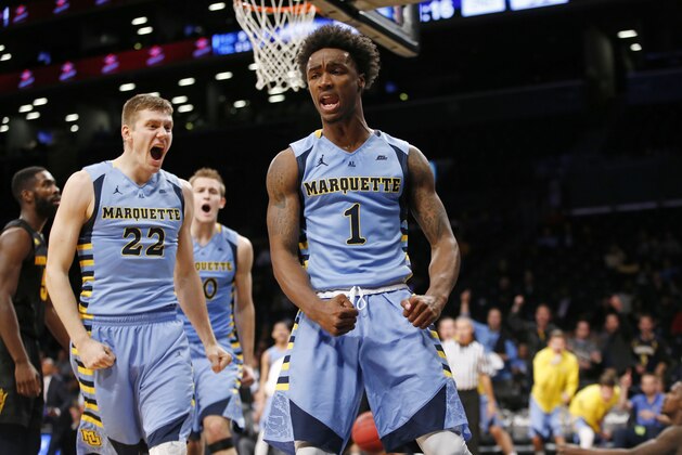 Marquette guards Wally Ellenson (22) and Duane Wilson (1) react in the second half of an NCAA college basketball game against Arizona State in the Legends Classic championship, Tuesday, Nov. 24, 2015, in New York. Marquette defeated Arizona State 78-73. (AP Photo/Kathy Willens)