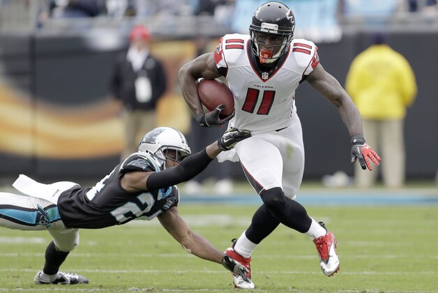 Atlanta Falcons' Julio Jones (11) looks up field as he runs away from Carolina Panthers' Josh Norman (24) during the first half of an NFL football game in Charlotte, N.C., Sunday, Nov. 16, 2014. The Falcons won 19-17. (AP Photo/Bob Leverone)