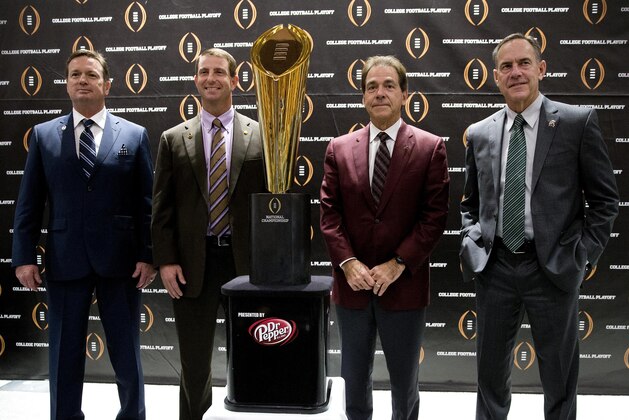 College football playoff coaches from left; Bob Stoops, of Oklahoma, Dabo Swenney, of Clemson, Nick Saban, of Alabama and Mark  Dontonio, of Michigan St., pose with the championship trophy after a news conference the college football awards at the College Football Hall of Fame  Thursday, Dec. 10, 2015, in Atlanta. Oklahoma and Clemson will meet in the Orange Bowl and Alabama and Michigan St. will play in the Cotton Bowl. (AP Photo/John Bazemore)