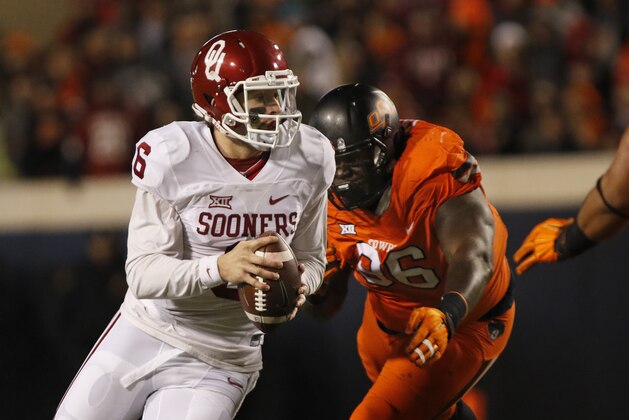 STILLWATER, OK - NOVEMBER 28 : Quarterback Baker Mayfield #6 of the Oklahoma Sooners scrambles under pressure from defensive tackle Vincent Taylor #96 of the Oklahoma State Cowboys November 28, 2015 at Boone Pickens Stadium in Stillwater, Oklahoma. Oklahoma defeated Oklahoma State 58-23.(Photo by Brett Deering/Getty Images)