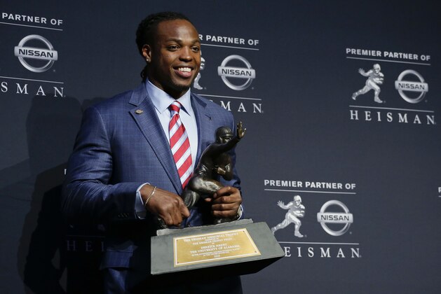 Alabama's Derrick Henry poses for photos after winning the Heisman Trophy, Saturday, Dec. 12, 2015, in New York. (AP Photo/Julie Jacobson)