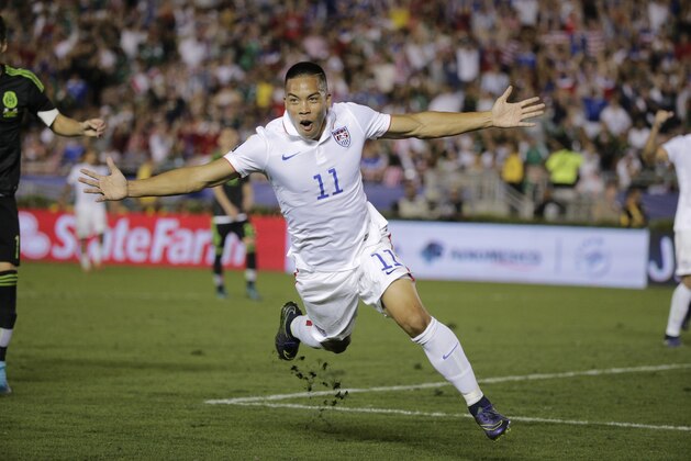 United States’ Bobby Wood celebrates scoring his side's 2nd goal against Mexico during the CONCACAF Confederations Cup playoff soccer match at the Rose Bowl Stadium, in Pasadena , Calif. Saturday, Oct. 10, 2015, (AP Photo/Jae C. Hong)