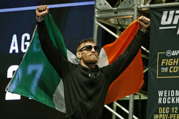 Conor McGregor walks on to the stage during the weigh-in for UFC 194 Friday, Dec. 11, 2015, in Las Vegas. McGregor is scheduled to fight Jose Aldo in a featherweight championship bout Saturday in Las Vegas. (AP Photo/John Locher)
