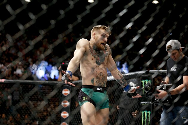 Conor McGregor reacts after defeating Jose Aldo during a featherweight  championship mixed martial arts bout at UFC 194, Saturday, Dec. 12, 2015, in Las Vegas. (AP Photo/John Locher)