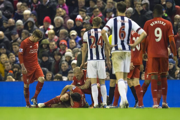 Liverpool's Dejan Lovren, bottom left, is seen injured on the pitch during the English Premier League soccer match between Liverpool and West Bromwich Albion at Anfield Stadium, Liverpool, England, Sunday, Dec. 13, 2015. (AP Photo/Jon Super)