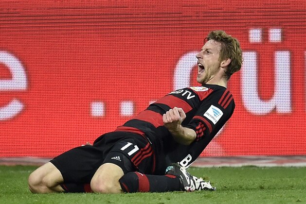 Leverkusen's Stefan Kiessling celebrates after scoring the opening goal during the German Bundesliga soccer match between Bayer Leverkusen and Borussia Moenchengladbach in Leverkusen, Germany, Saturday, Dec. 12, 2015. (AP Photo/Martin Meissner)
