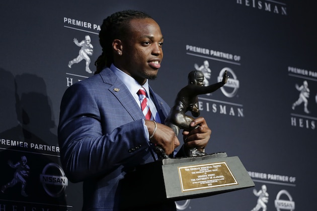 Alabama's Derrick Henry poses for photos after winning the Heisman Trophy, Saturday, Dec. 12, 2015, in New York. (AP Photo/Julie Jacobson)