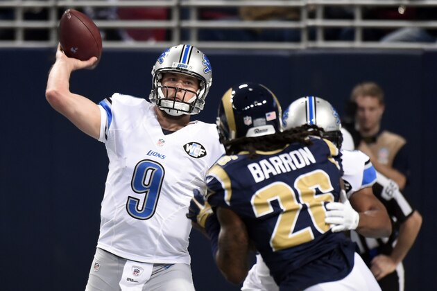 Detroit Lions quarterback Matthew Stafford, left, throws under pressure from St. Louis Rams strong safety Mark Barron during the first quarter of an NFL football game Sunday, Dec. 13, 2015, in St. Louis. (AP Photo/L.G. Patterson)